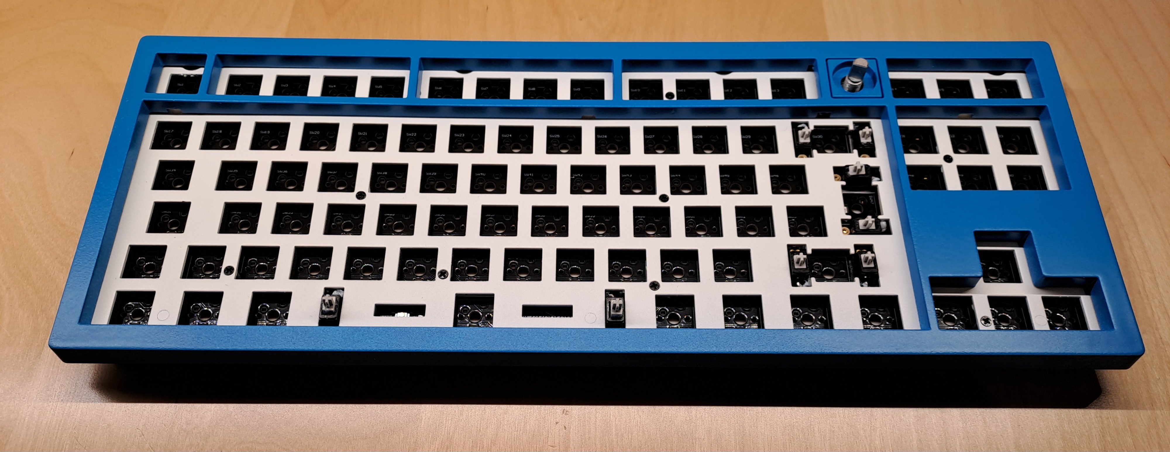 The keyboard in the {CodeStore} main colors without keycaps and switches